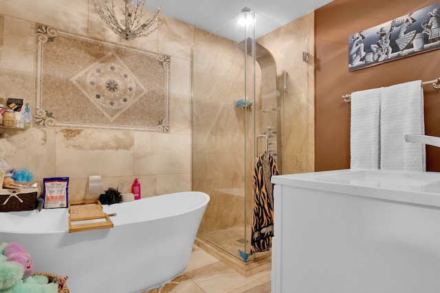 bathroom featuring tile walls, tile patterned flooring, vanity, and plus walk in shower