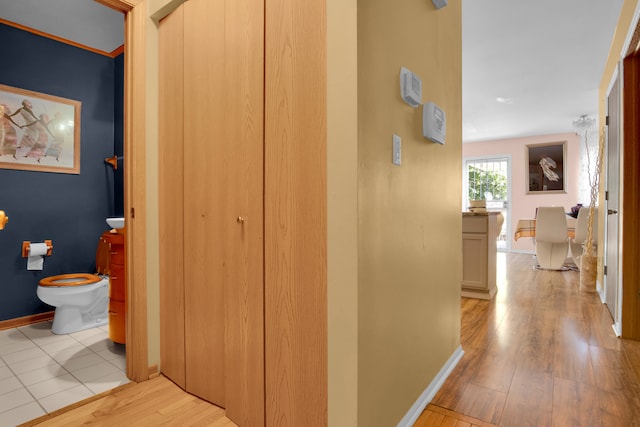 corridor with light hardwood / wood-style flooring