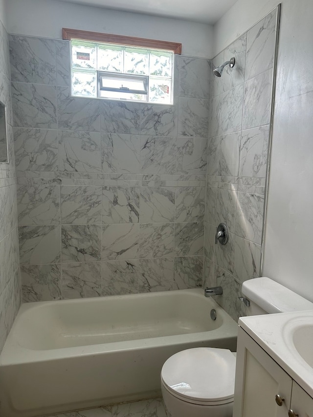 full bathroom featuring vanity, toilet, and tiled shower / bath