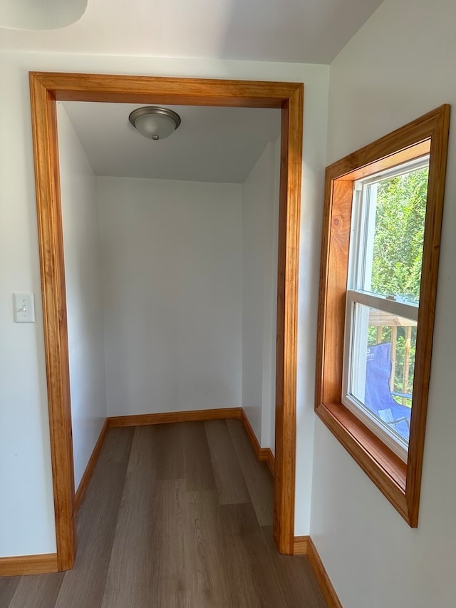 corridor with hardwood / wood-style floors