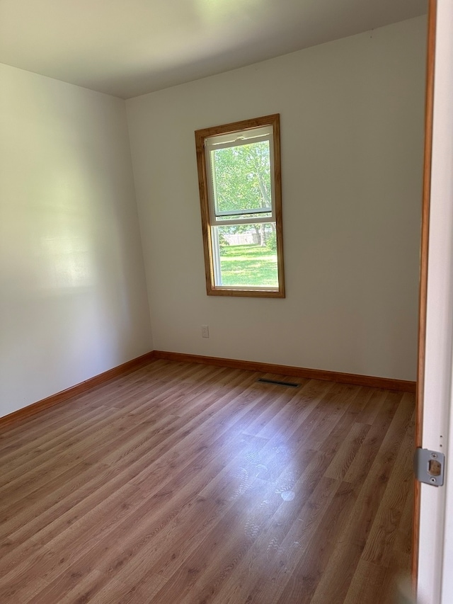 spare room featuring hardwood / wood-style flooring