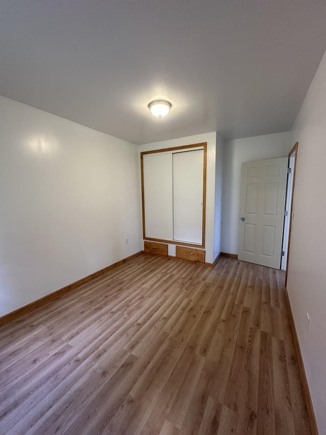 705 N Cottage Ave, Kankakee, IL 60901 - unfurnished bedroom with wood finished floors and a closet