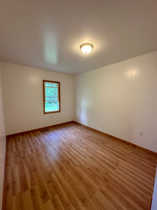 spare room featuring light hardwood / wood-style floors