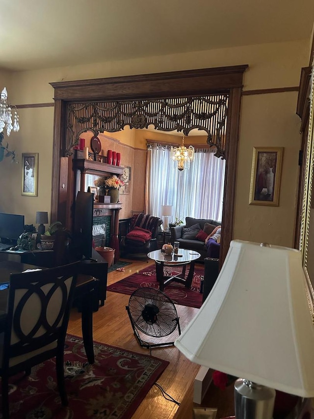 living room featuring an inviting chandelier and hardwood / wood-style flooring