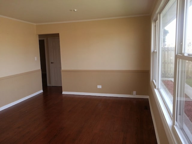 spare room with dark hardwood / wood-style flooring and ornamental molding