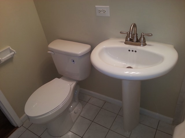 bathroom featuring toilet and tile patterned flooring