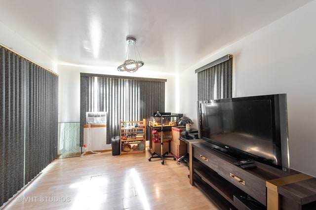 home office with light hardwood / wood-style flooring