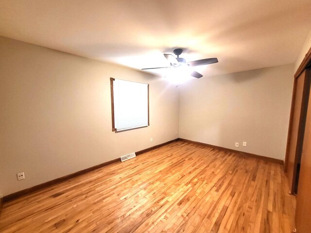 empty room featuring ceiling fan and light hardwood / wood-style floors