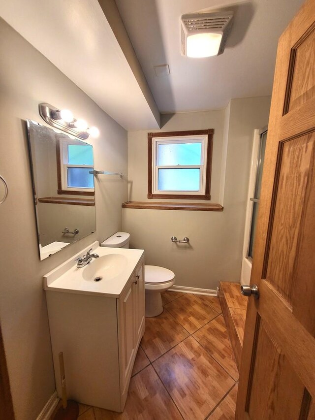 bathroom featuring hardwood / wood-style floors, toilet, and vanity