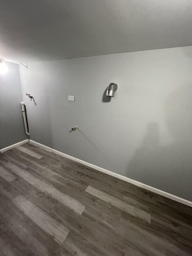 laundry area featuring baseboards and dark wood finished floors