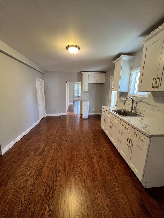 kitchen with dark wood-style floors, white cabinets, a sink, and light countertops