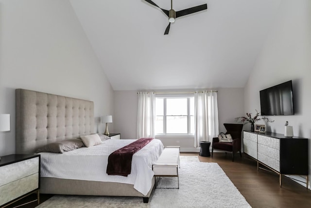 bedroom with dark wood-style floors, ceiling fan, and vaulted ceiling