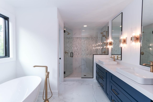 bathroom featuring a freestanding tub, a sink, marble finish floor, and a marble finish shower