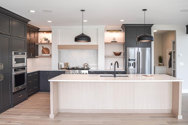 kitchen with high end refrigerator, a sink, light countertops, open shelves, and pendant lighting