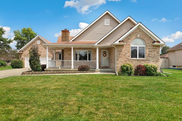 view of front of house featuring a garage, a front yard, and covered porch