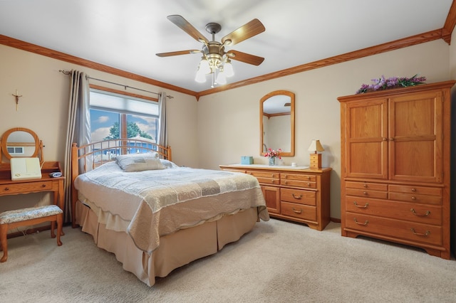 carpeted bedroom featuring ornamental molding and ceiling fan