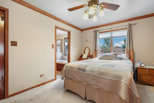 carpeted bedroom with ornamental molding, ensuite bath, and ceiling fan