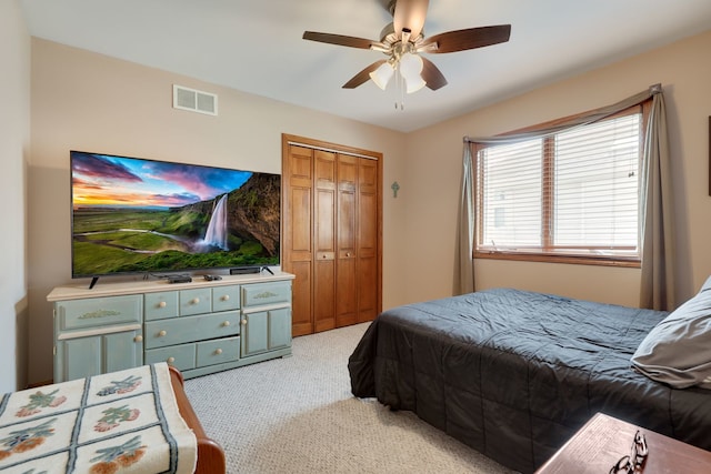 carpeted bedroom with a closet and ceiling fan