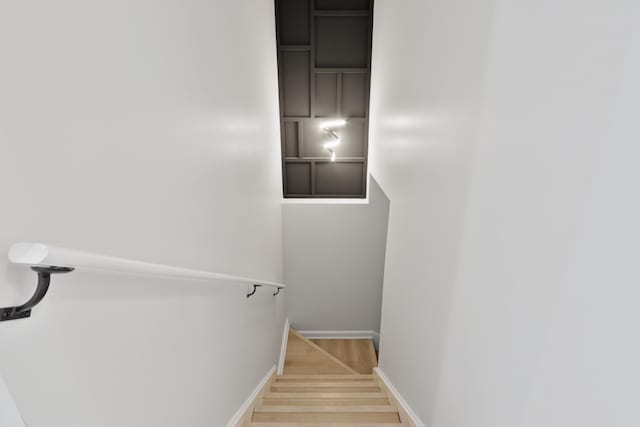 stairs featuring light hardwood / wood-style flooring