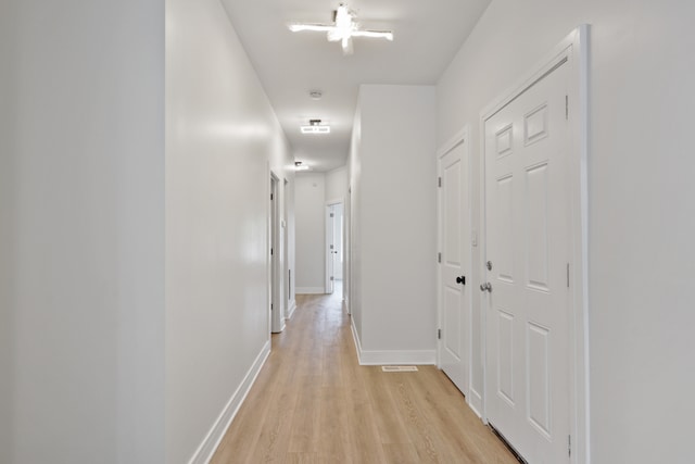 corridor featuring light hardwood / wood-style floors