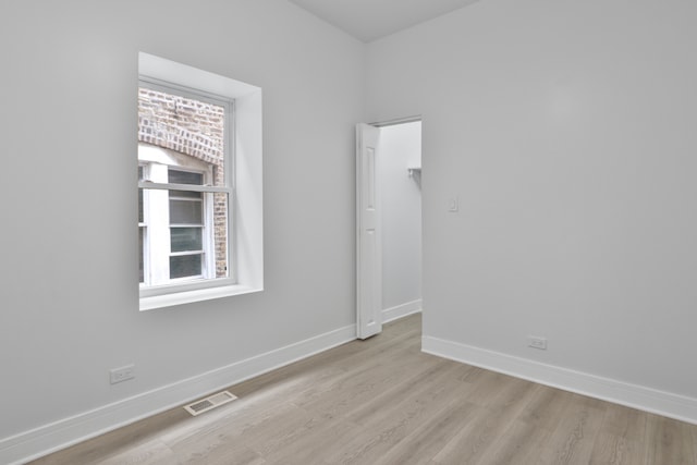 spare room with light wood-type flooring