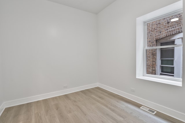 empty room with light hardwood / wood-style floors