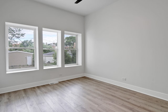 empty room with ceiling fan and light wood-type flooring