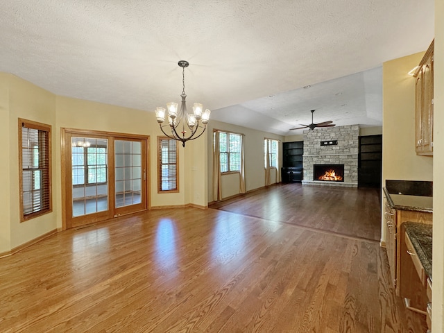 interior space with a fireplace, a textured ceiling, and hardwood / wood-style flooring