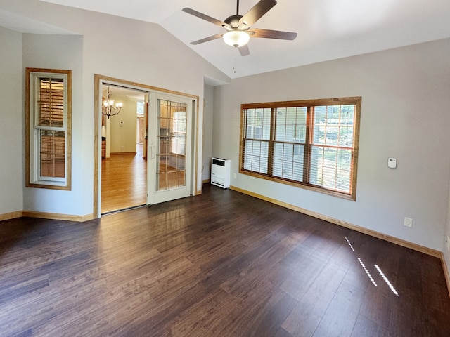 spare room featuring vaulted ceiling, ceiling fan with notable chandelier, and hardwood / wood-style floors