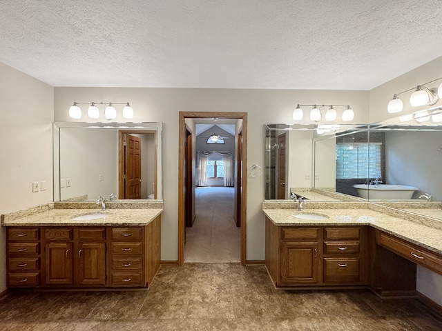 bathroom with tile patterned floors, double vanity, a textured ceiling, and toilet