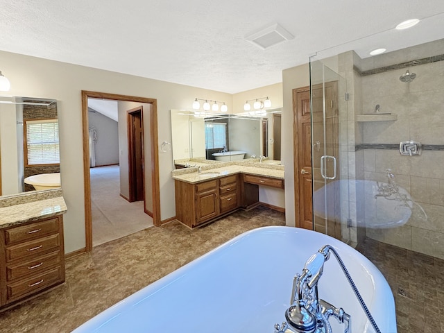 bathroom featuring vanity, a textured ceiling, independent shower and bath, and tile patterned flooring