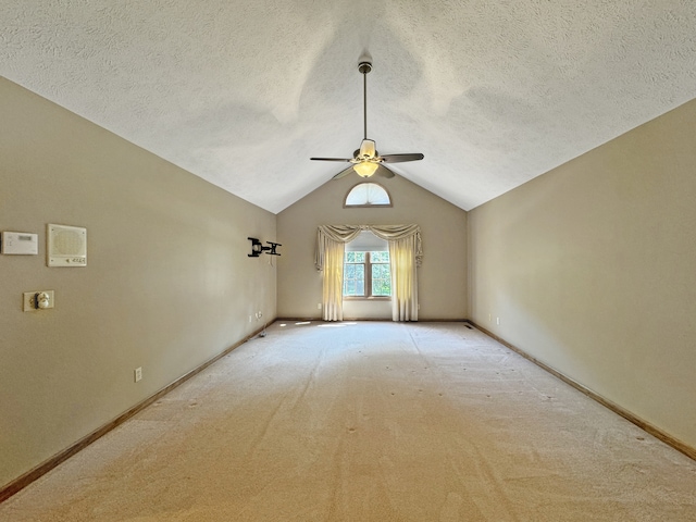 unfurnished room featuring ceiling fan, a textured ceiling, lofted ceiling, and light carpet