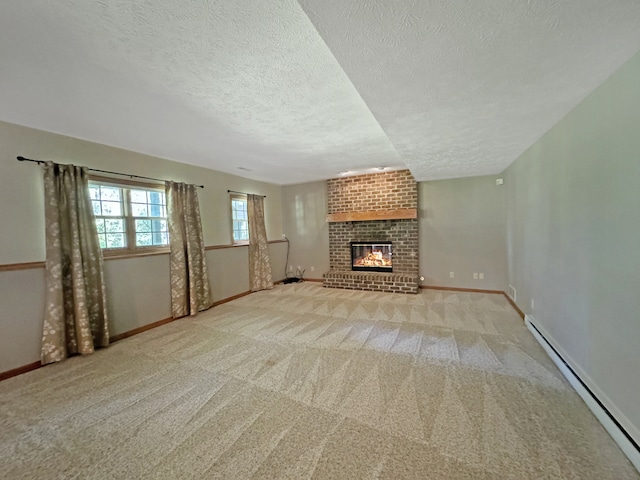 unfurnished living room with a textured ceiling, carpet, a baseboard radiator, a fireplace, and brick wall