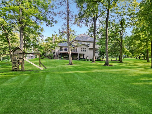 view of yard with a playground and a wooden deck