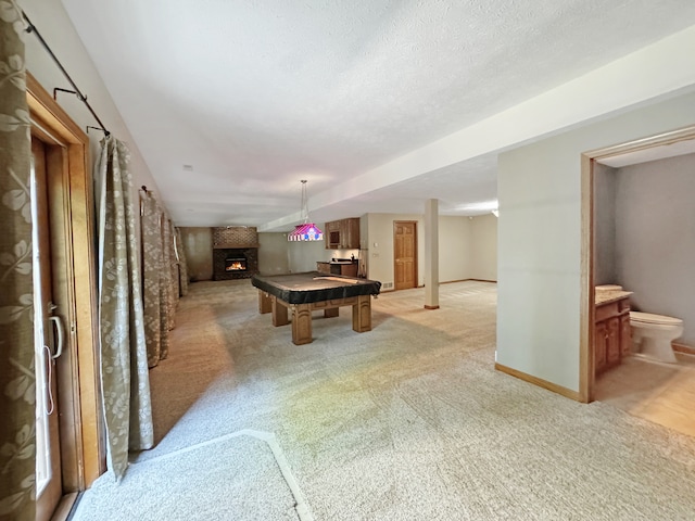 game room with pool table, a textured ceiling, and light carpet