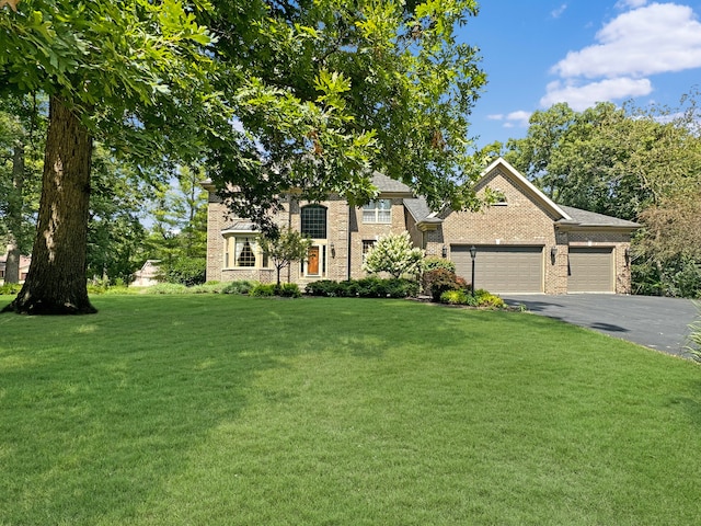 view of front of house with a garage and a front lawn