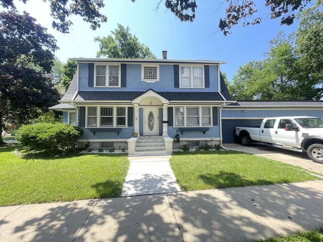 view of front of property with a garage and a front yard