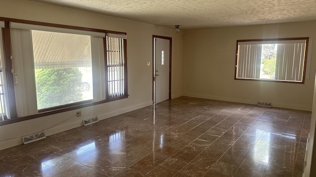 spare room with visible vents and baseboards