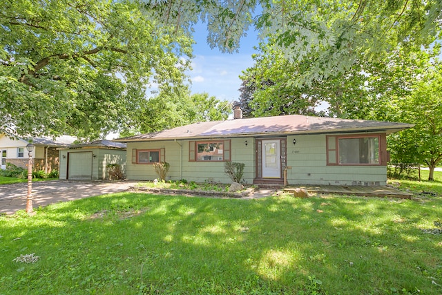 single story home featuring a garage and a front lawn