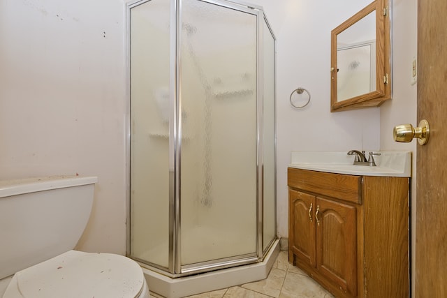 bathroom with vanity, toilet, an enclosed shower, and tile patterned flooring