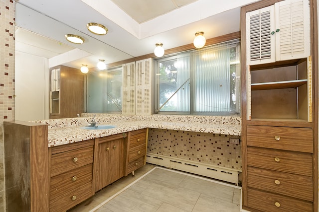 bathroom with tile patterned floors, a baseboard radiator, and vanity