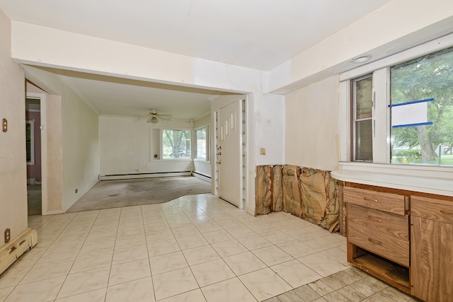 interior space with tile patterned floors, a baseboard radiator, and ceiling fan