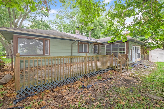 rear view of property with an outdoor structure and a wooden deck