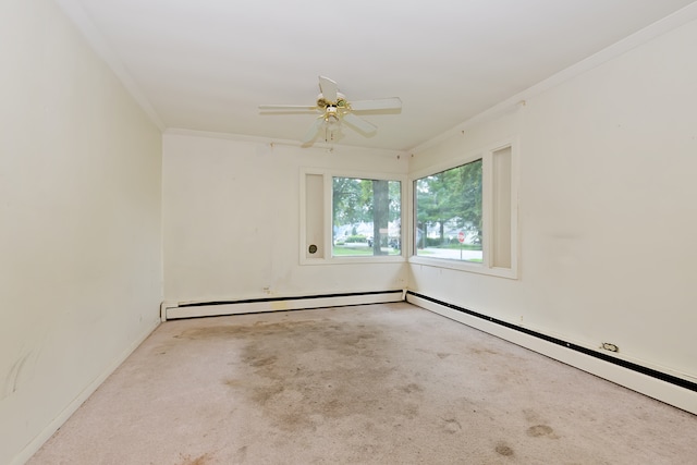 empty room featuring light colored carpet, a baseboard heating unit, ceiling fan, and crown molding