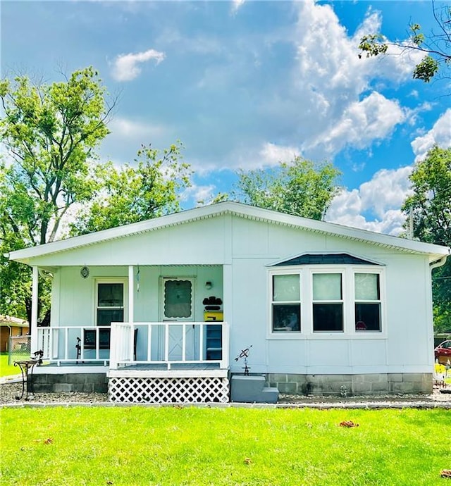 back of house with a yard and covered porch