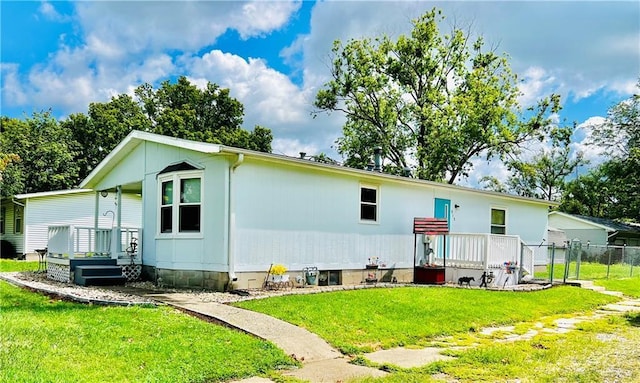 rear view of property featuring a lawn