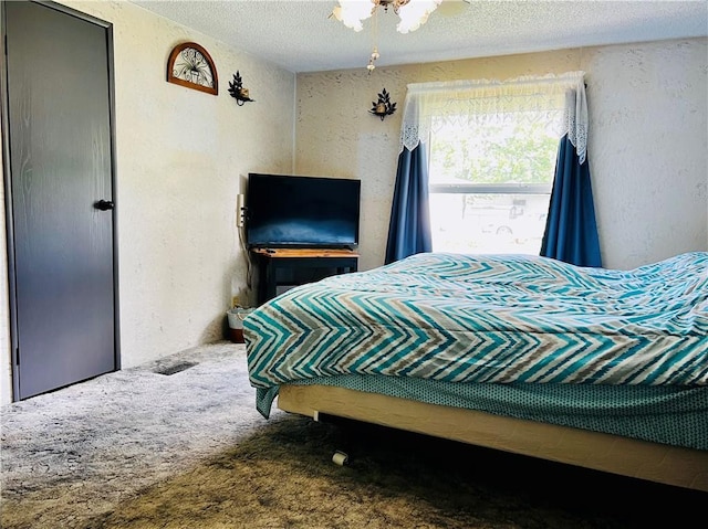 carpeted bedroom featuring a textured ceiling