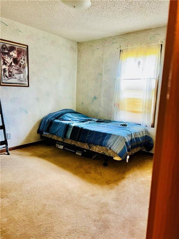 bedroom featuring carpet and a textured ceiling