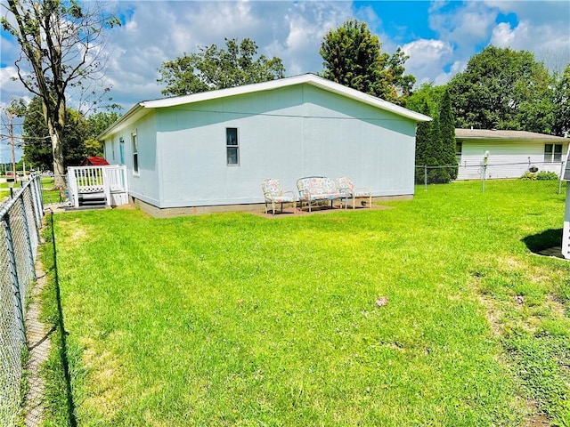 rear view of house with a yard