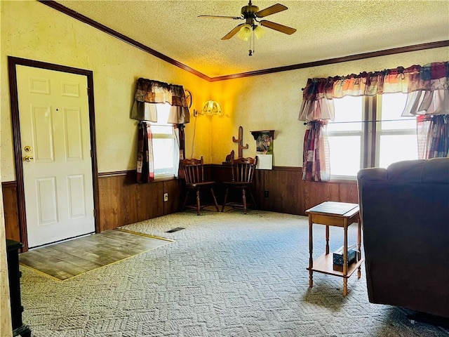 interior space featuring ceiling fan, carpet flooring, and a textured ceiling